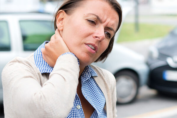 Woman holding neck after a car wreck