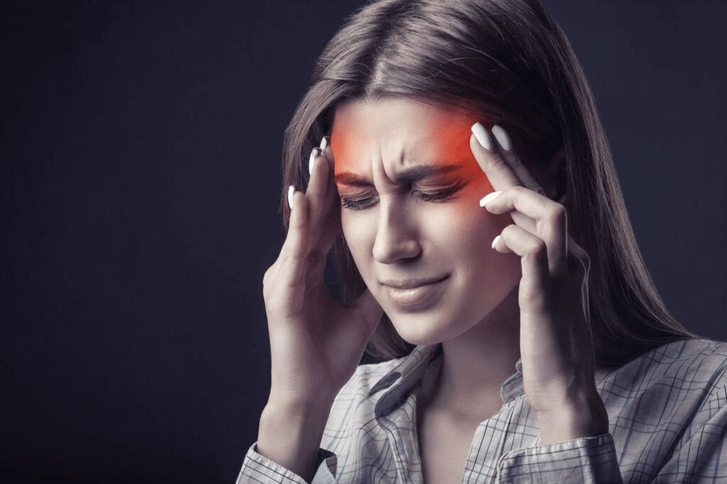 Girl holding head from headache